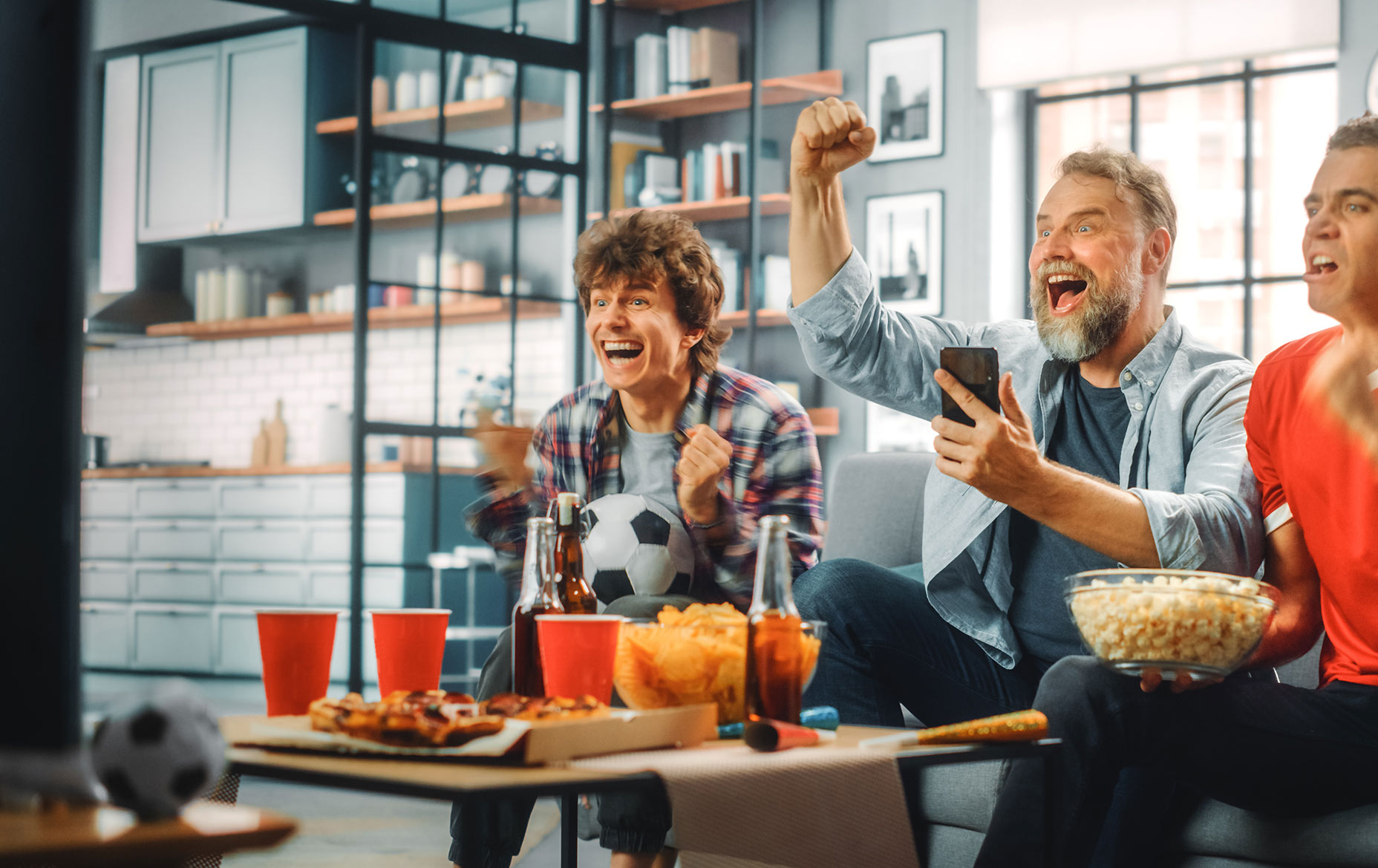 Family enjoying a game on TV