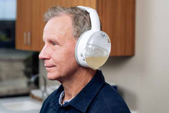 Man getting earwax cleaned using OtoSet disposables.